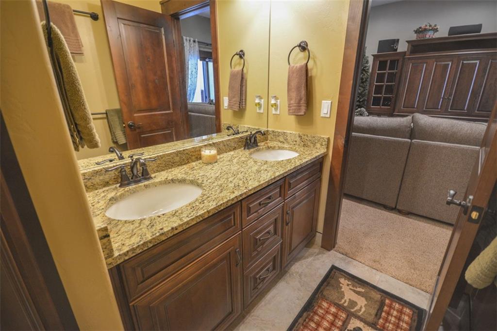 835 Independence Road, Unit 6B Keystone, CO 80435 - Photo 28 of 30 a bathroom with a granite countertop sink a mirror and a shower