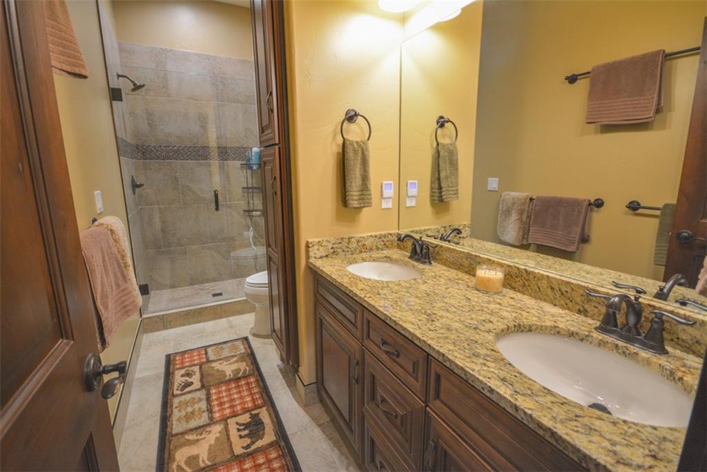 835 Independence Road, Unit 6B Keystone, CO 80435 - Photo 10 of 30 a bathroom with a granite countertop sink a mirror and a shower