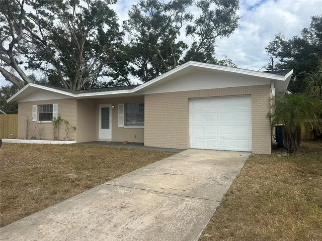 a front view of house with yard and trees