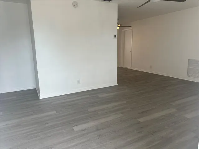 an empty room with wooden floor