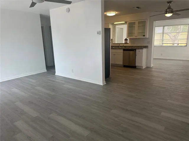 a view of kitchen with refrigerator sink and wooden floor