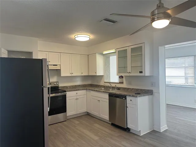 a kitchen with a sink stove and refrigerator