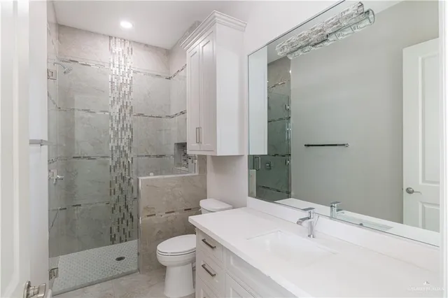 a bathroom with a sink toilet and shower