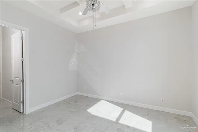an empty room with a ceiling fan and a window