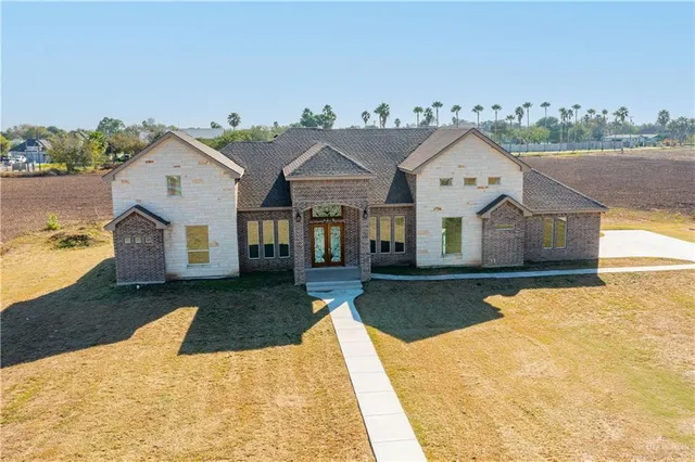 a view of a white house with a yard