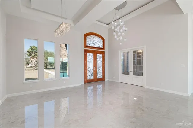 an empty room with windows and entrance