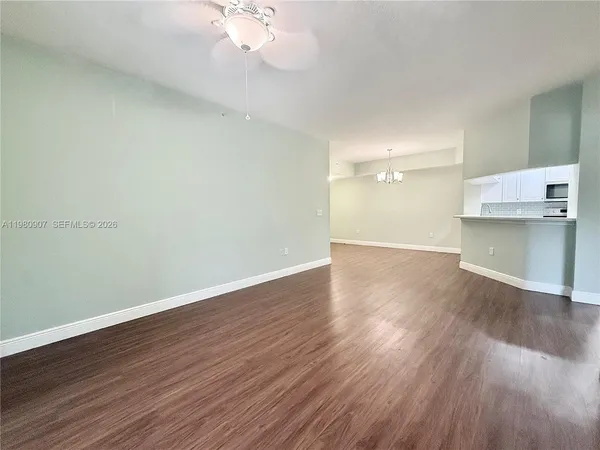 a view of a room with wooden floor and stove