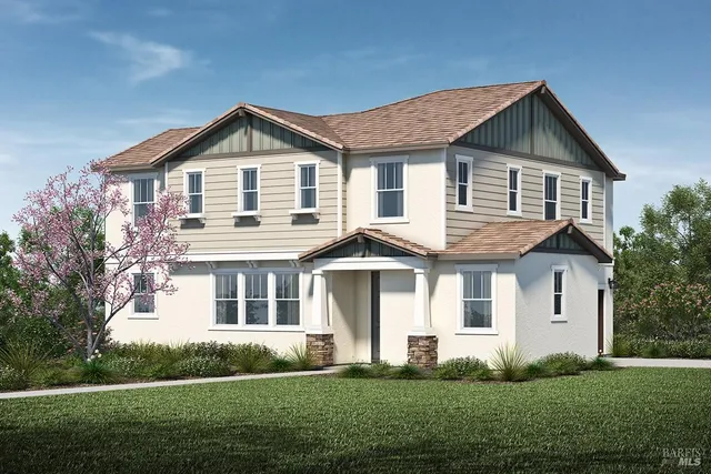 a front view of a house with a yard and trees