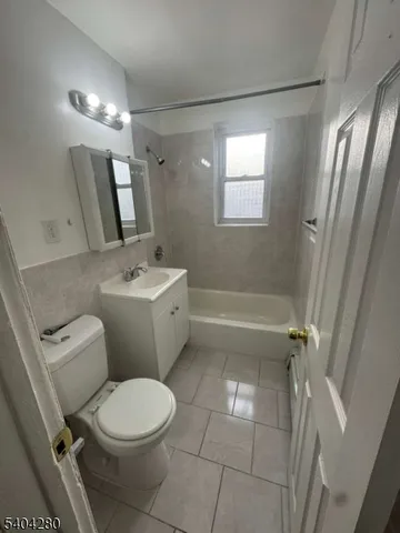 a white toilet sitting next to a bathroom sink and tub