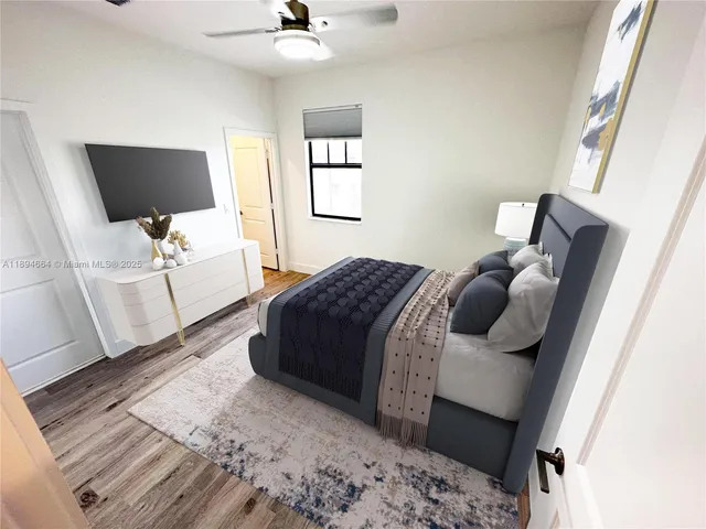 a bedroom with a bed and flat screen tv