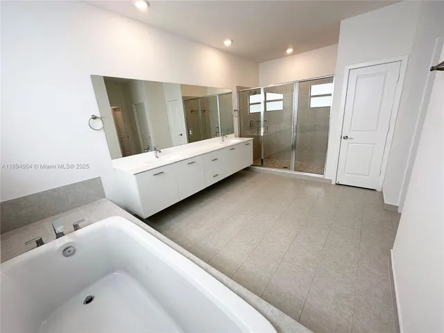 a bathroom with a bathtub and a shower