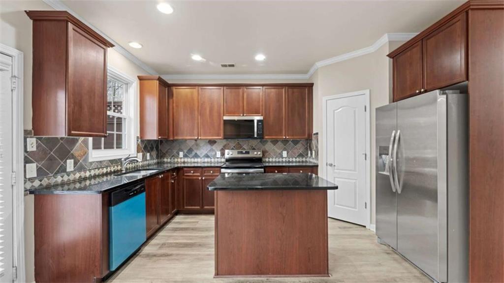 2620 Ridge Run Trail Duluth, GA 30097 - Photo 11 of 34 a kitchen with stainless steel appliances granite countertop a stove a refrigerator and a sink