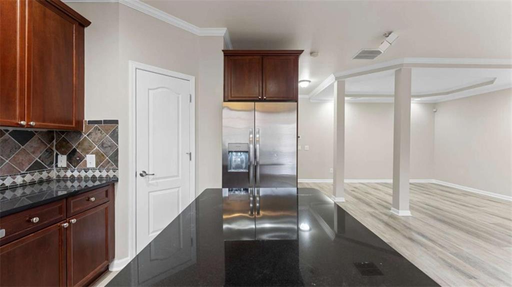 2620 Ridge Run Trail Duluth, GA 30097 - Photo 13 of 34 a kitchen with stainless steel appliances granite countertop a refrigerator a sink and wooden cabinets