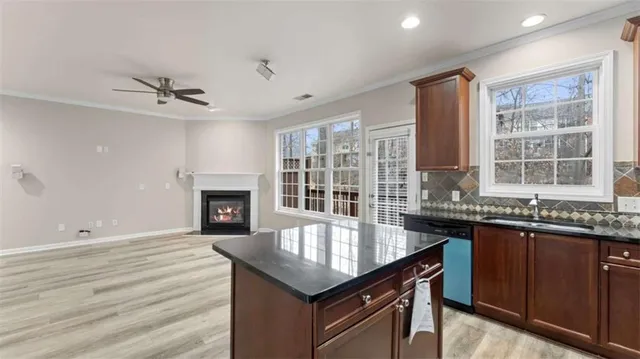 a kitchen with granite countertop stainless steel appliances a sink stove and oven