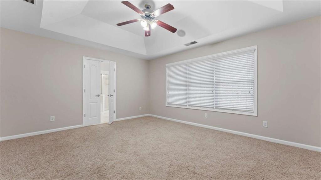2620 Ridge Run Trail Duluth, GA 30097 - Photo 16 of 34 an empty room with chandelier fan and windows