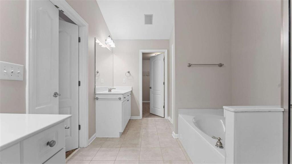 2620 Ridge Run Trail Duluth, GA 30097 - Photo 19 of 34 a bathroom with a tub sink and mirror
