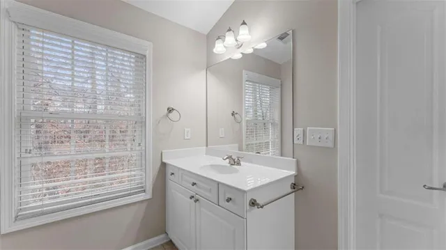 a bathroom with a sink a mirror and a shower