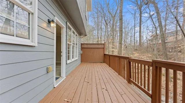 a view of a balcony with wooden floor and fence