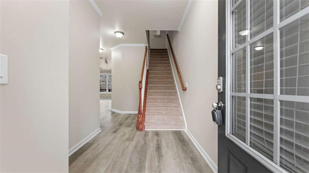 2620 Ridge Run Trail Duluth, GA 30097 - Photo 7 of 34 a view of a hallway with wooden floor and stairs