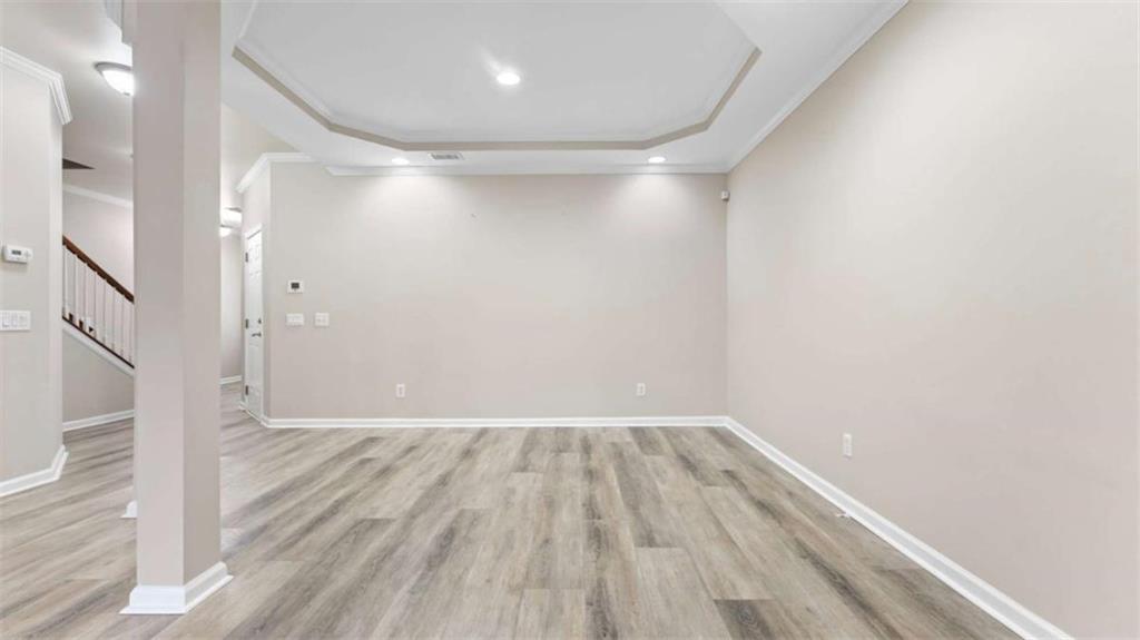 2620 Ridge Run Trail Duluth, GA 30097 - Photo 10 of 34 a view of an empty room with wooden floor and a window