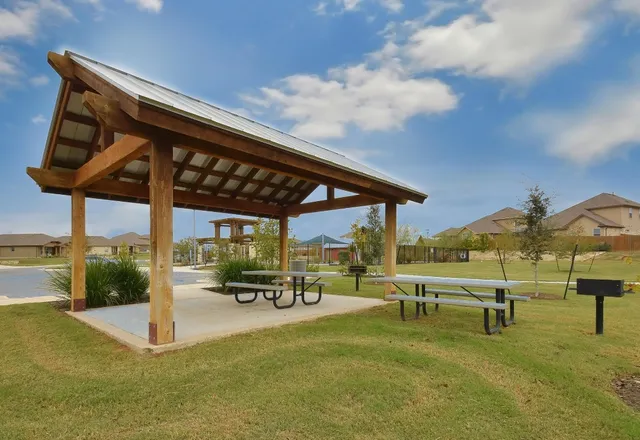 a swimming pool with outdoor seating and yard