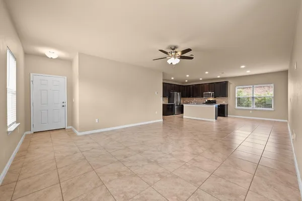 a view of a livingroom with a kitchen and a stove