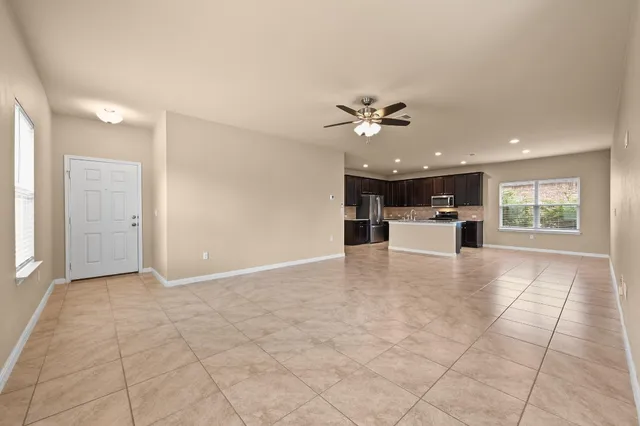 a view of a livingroom with a kitchen and a stove
