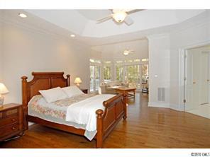 15 Catawba Ridge Road Lake Wylie, SC 29710 - Photo 8 of 16 a bedroom with a bed a table and chandelier