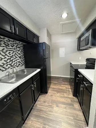 a kitchen with stainless steel appliances a sink stove and refrigerator