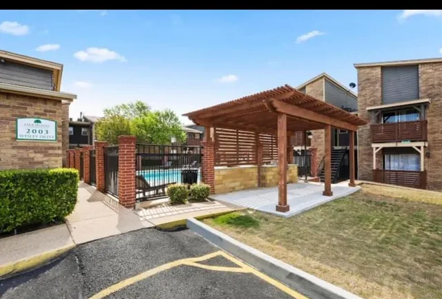 a view of a house with backyard and sitting area