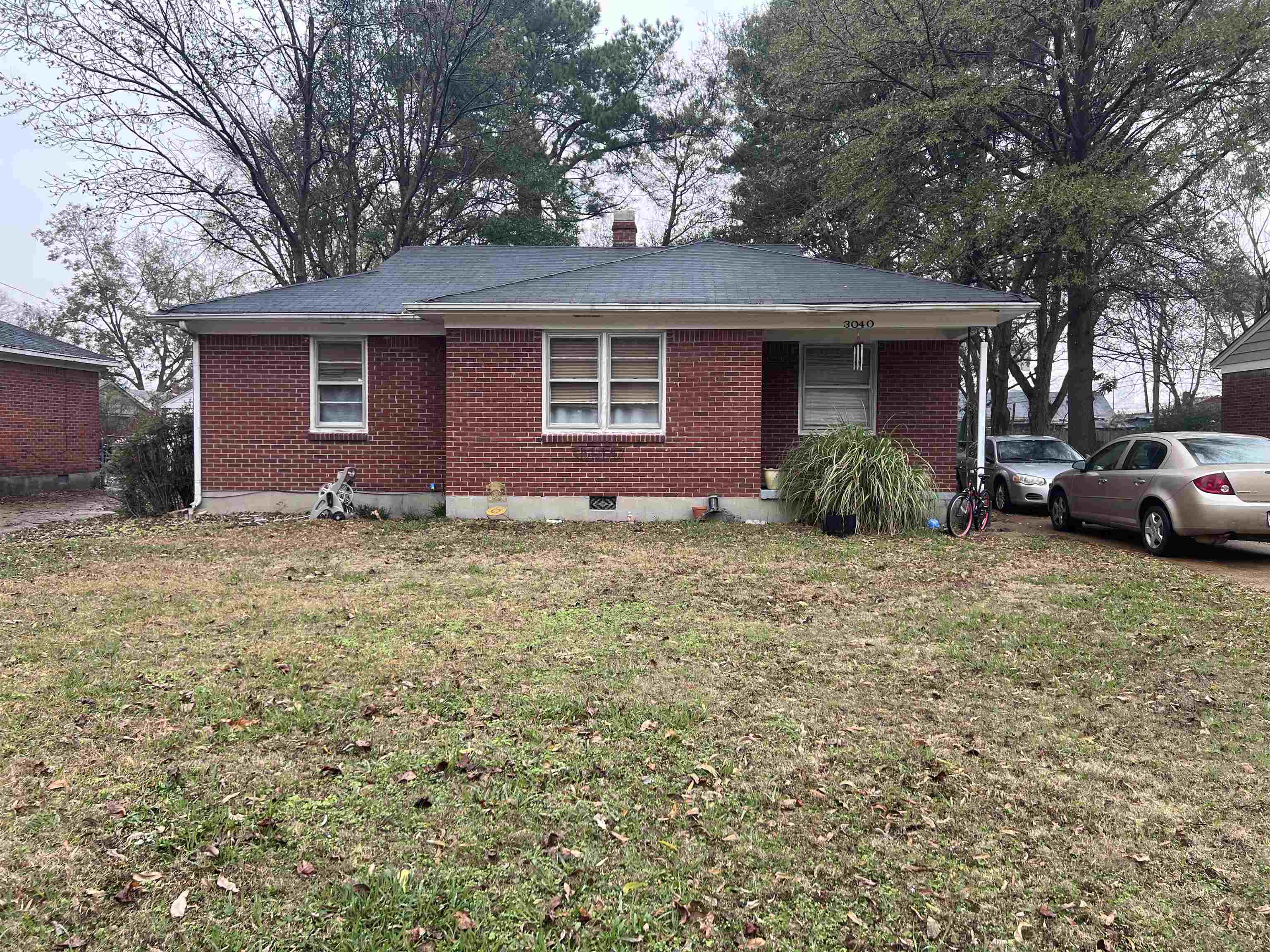 3040 South Edgeware Road Memphis, TN 38118 - Photo 1 of 12 Single story home with brick siding, a front yard, and a chimney