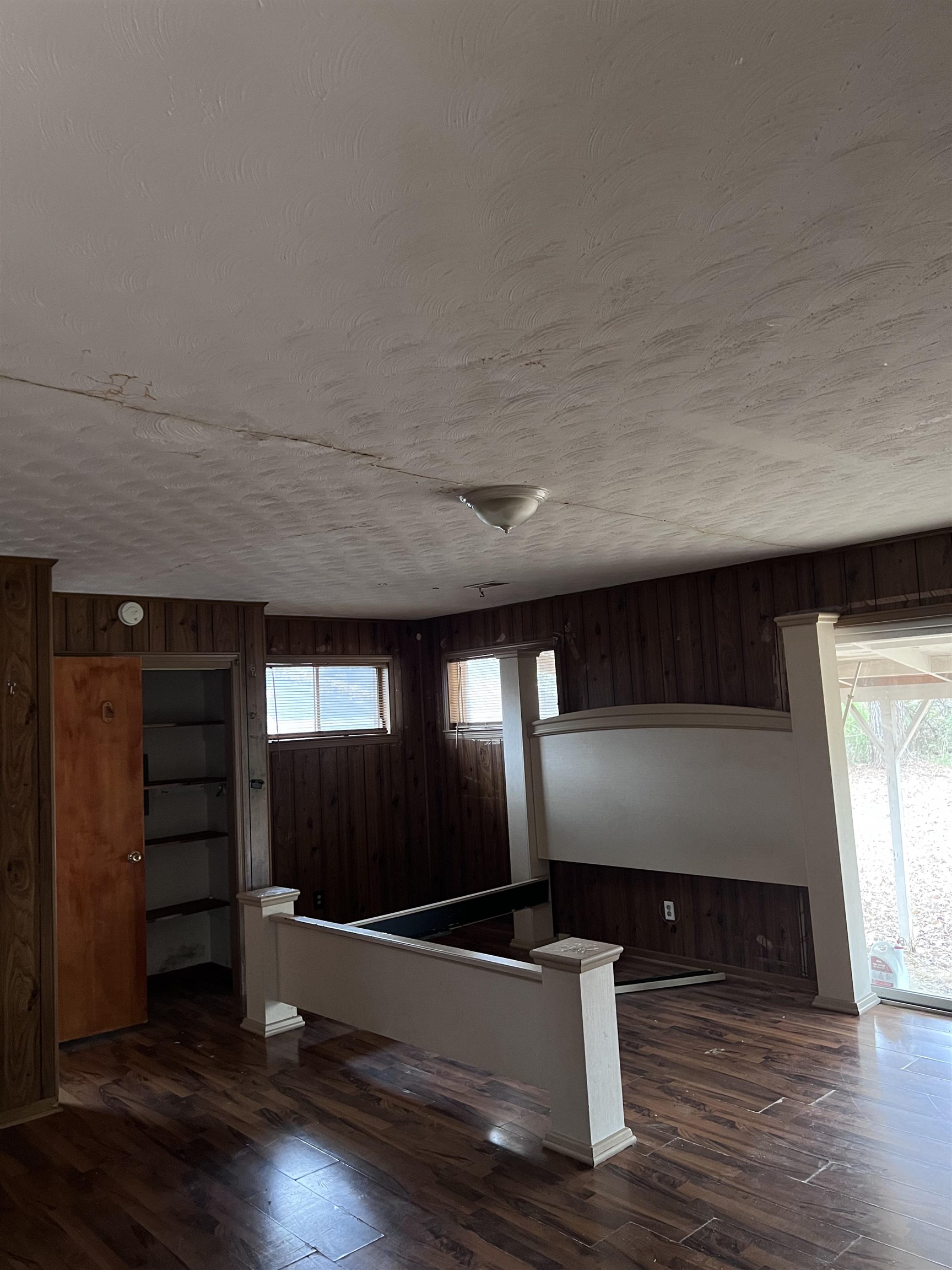 3040 South Edgeware Road Memphis, TN 38118 - Photo 12 of 12 Basement featuring plenty of natural light, dark wood finished floors, and wooden walls