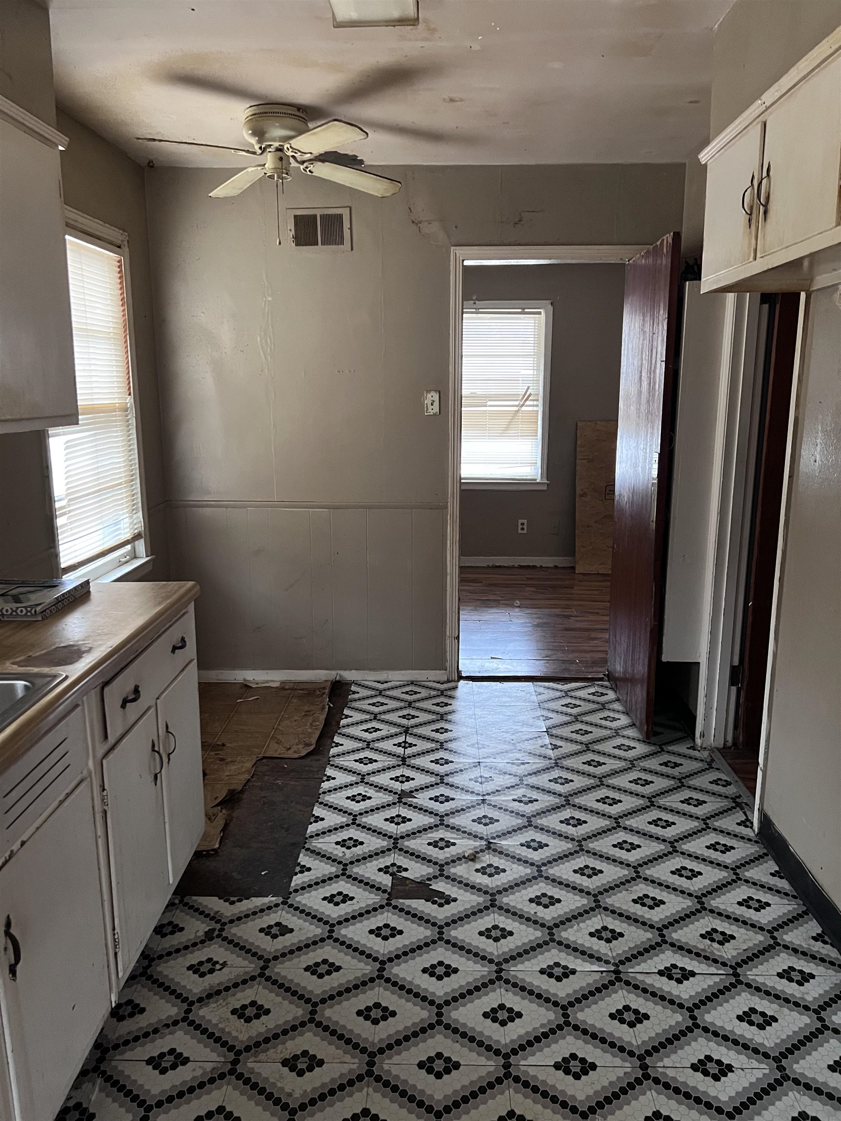 3040 South Edgeware Road Memphis, TN 38118 - Photo 8 of 12 Kitchen featuring white cabinetry, ceiling fan, healthy amount of natural light, and light countertops