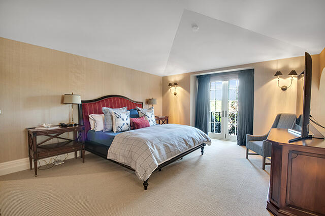 17791 Saxony Court Boca Raton, FL 33496 - Photo 19 of 41 a spacious bedroom with a bed and a chandelier
