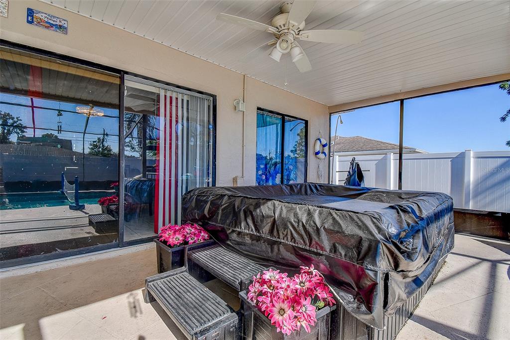 10440 Laval Street Spring Hill, FL 34608 - Photo 14 of 44 a bedroom with a bed and a chandelier