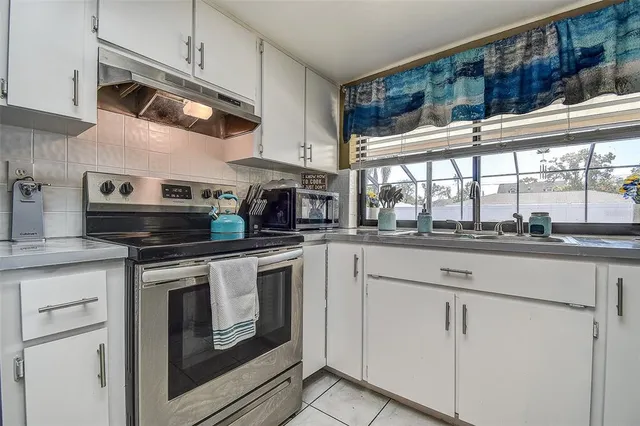 a kitchen with stainless steel appliances kitchen island granite countertop a sink and cabinets