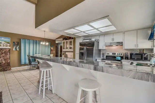 a kitchen with a sink cabinets and window