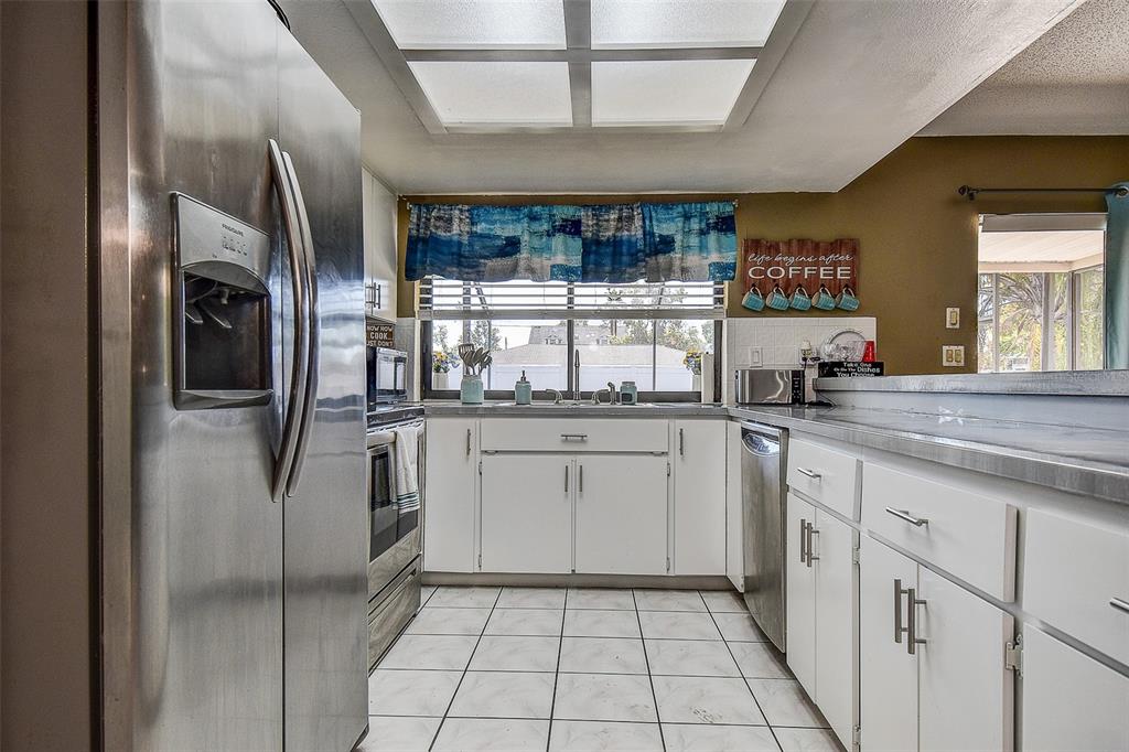 10440 Laval Street Spring Hill, FL 34608 - Photo 18 of 44 a kitchen with stainless steel appliances granite countertop a refrigerator and a sink
