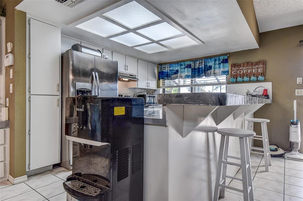 10440 Laval Street Spring Hill, FL 34608 - Photo 19 of 44 a kitchen with stainless steel appliances granite countertop a refrigerator and a stove top oven
