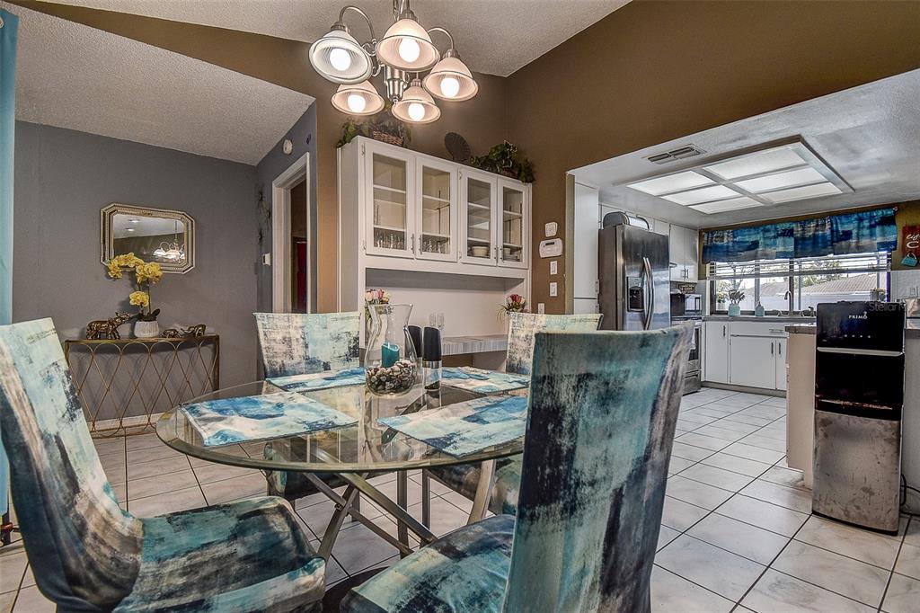10440 Laval Street Spring Hill, FL 34608 - Photo 20 of 44 a view of a dining room with furniture and chandelier