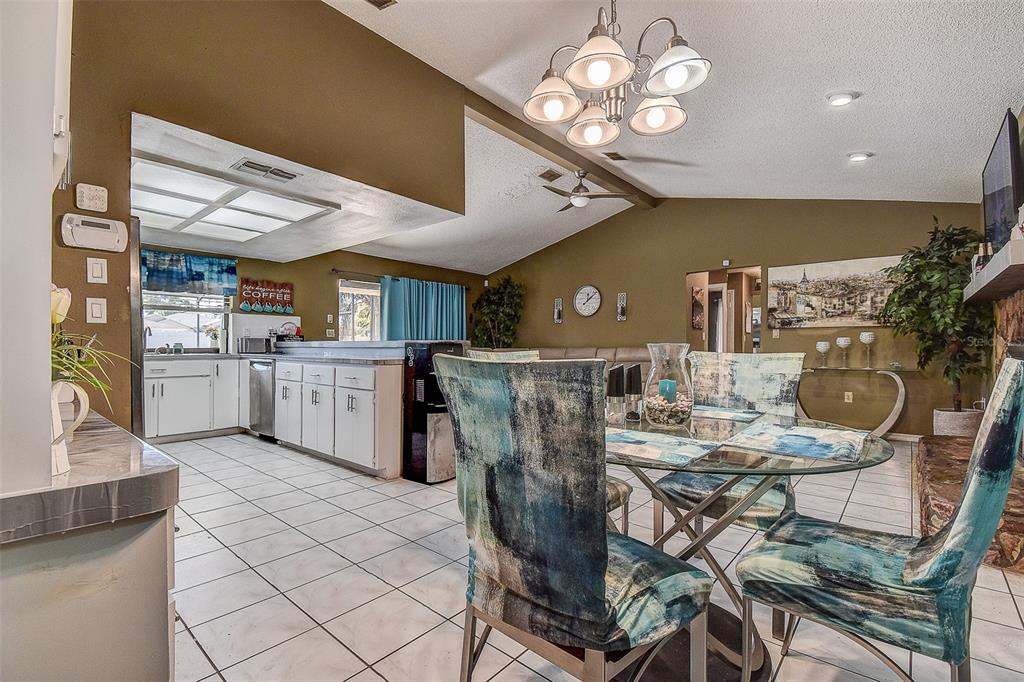10440 Laval Street Spring Hill, FL 34608 - Photo 21 of 44 a view of a dining room with furniture and chandelier