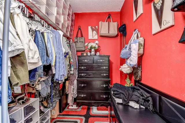 a living room with a flat screen tv and gym equipment