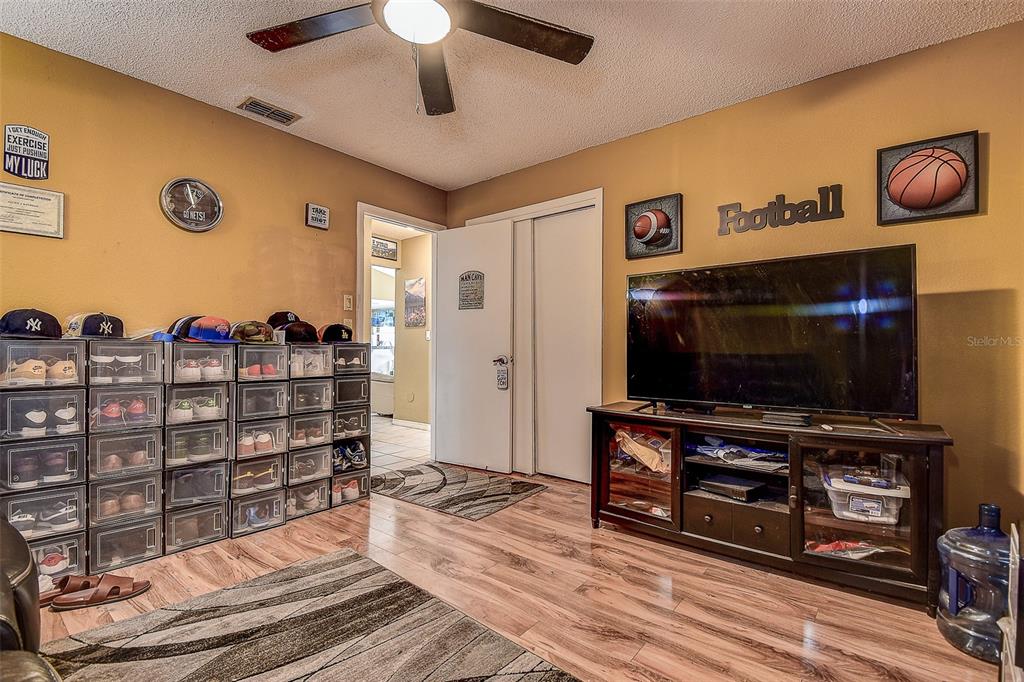 10440 Laval Street Spring Hill, FL 34608 - Photo 33 of 44 a living room with a flat screen tv and gym equipment