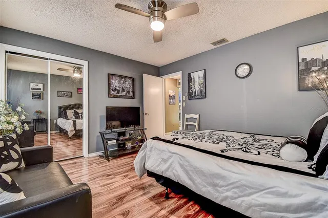 a bedroom with a bed and a chandelier