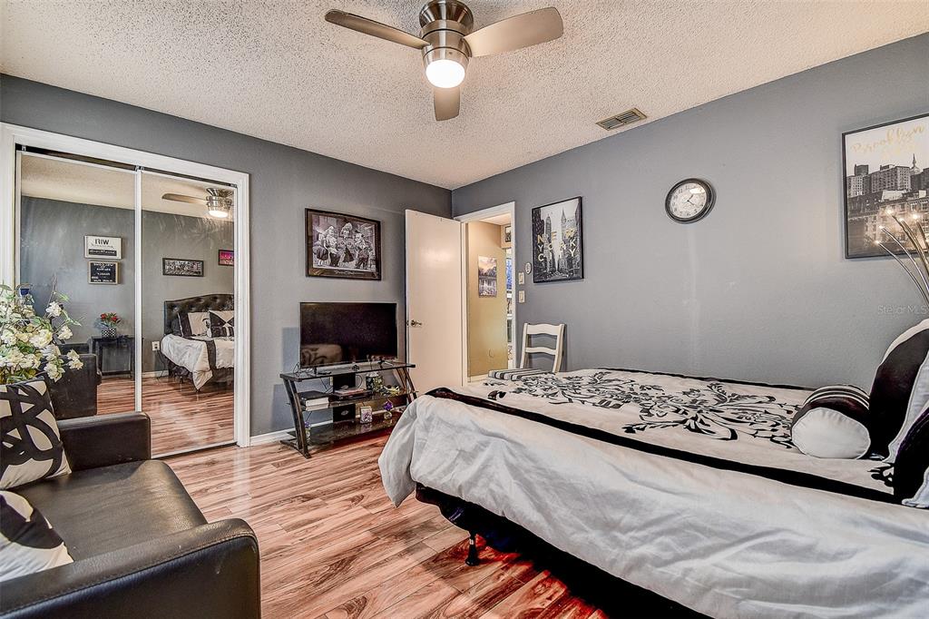 10440 Laval Street Spring Hill, FL 34608 - Photo 35 of 44 a bedroom with a bed and wooden floor