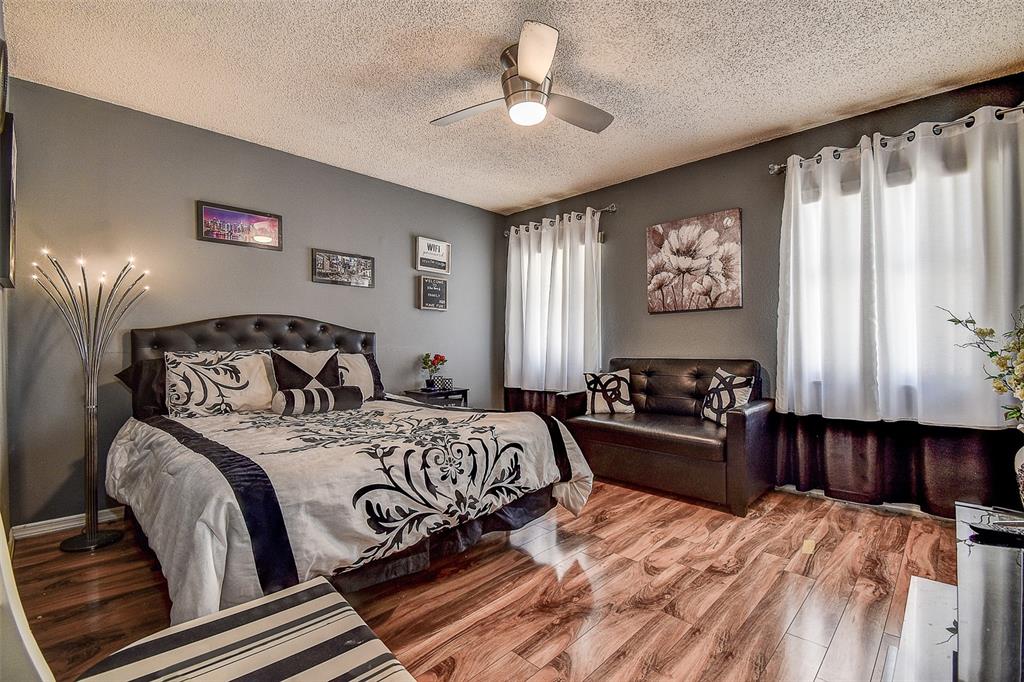 10440 Laval Street Spring Hill, FL 34608 - Photo 36 of 44 a bedroom with a bed and a chandelier