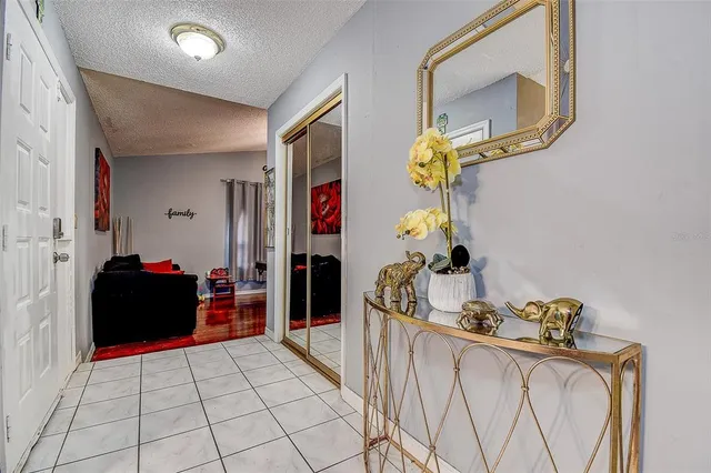 a view of a hallway with closet and bathroom
