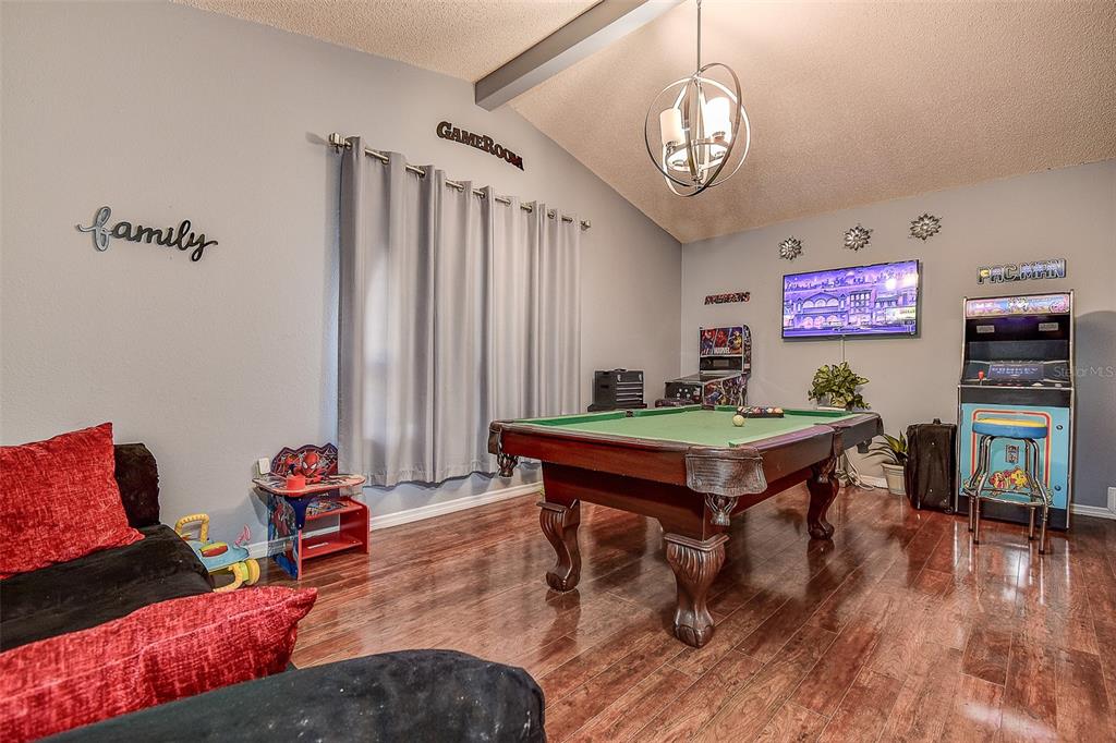 10440 Laval Street Spring Hill, FL 34608 - Photo 41 of 44 a living room with furniture a rug and a chandelier