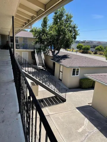 a view of house with roof deck and furniture