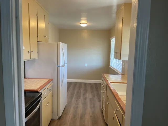 a view of walk in closet and wooden floor